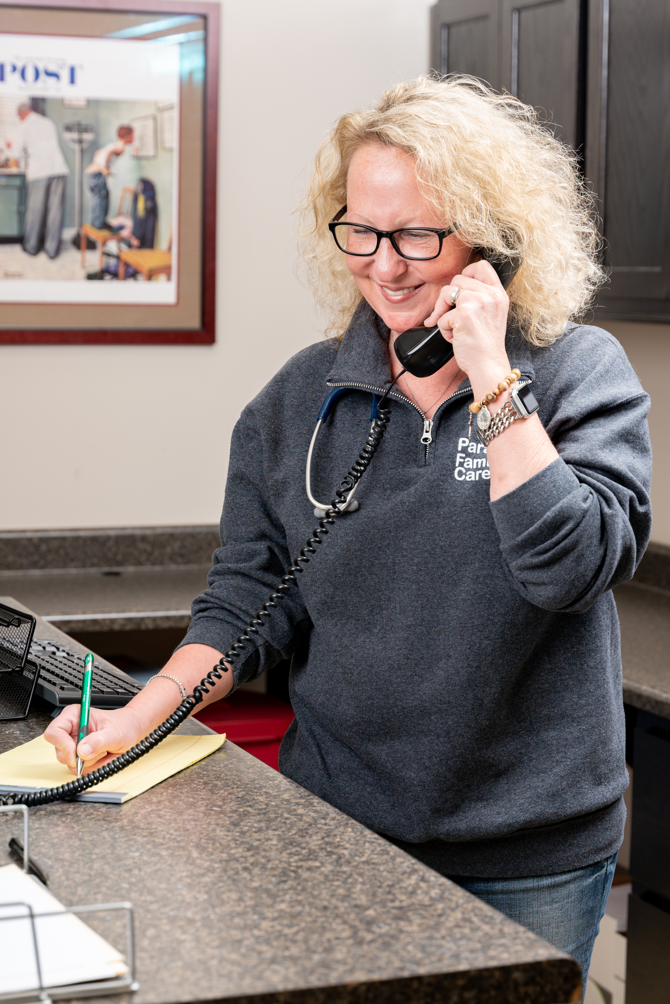 Paragould Family Care front desk team member helping a patient